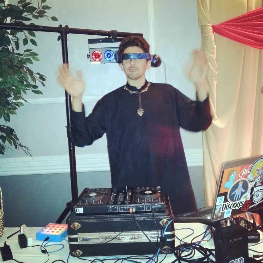 DJ Snickelfritz performing behind a DJ controller at an event